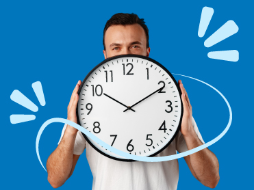 Man holding a large clock in his hands